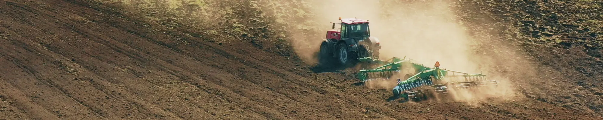 Tractor in action on the farm – Promoting eco-conscious agriculture with World Climate Farm Tool for carbon footprints
