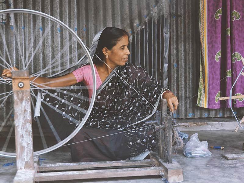 woman at spinning wheel fair trade